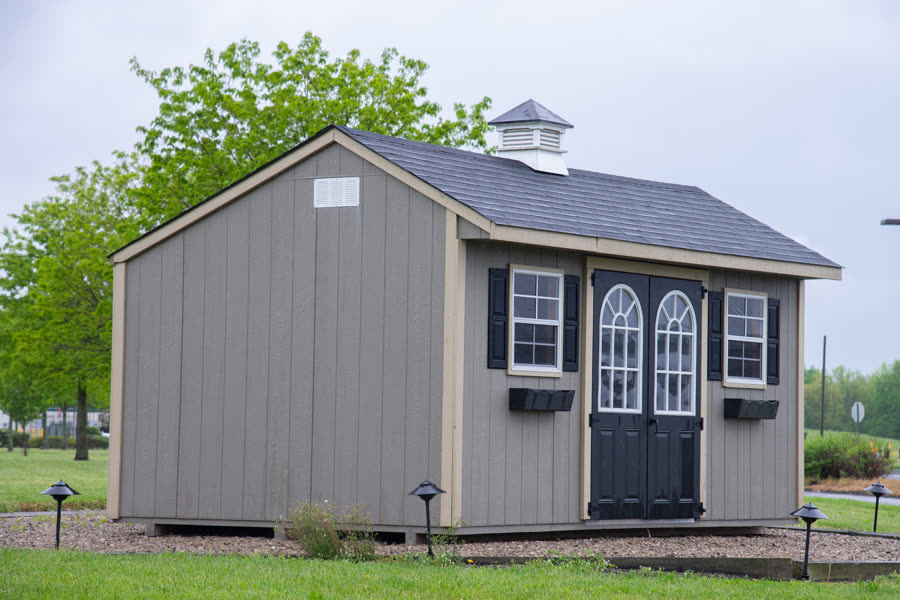 Custom backyard shed with double doors and shutters